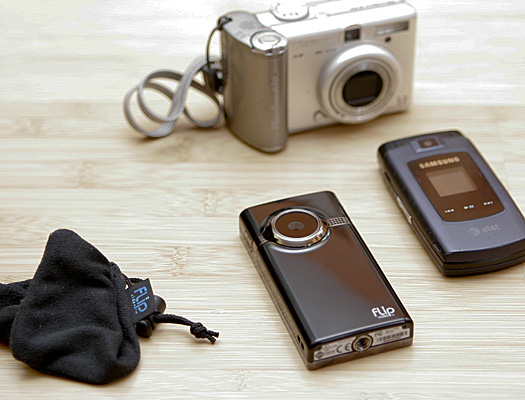 Cell phone comparison photo The Flip Mino HD is about 1/8 inch larger than my cell phone.