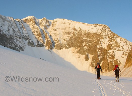 The morning sun hits the Laundry Chutes as we skin toward the base. We skied the couloir second from the left.