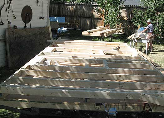 Portable backcountry skiing hut. Without a large flat deck to work on (the wheels protrude), squaring and sheathing the walls reguired some extra work, but turned out fine. Scott and I found the side walls were too heavy for a quick lift so we had to do some Egyptian engineering to get them up.
