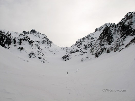 Skylergoatvalley Into the valley of the shadow of snow; Skyler skinning below Goat Peak.