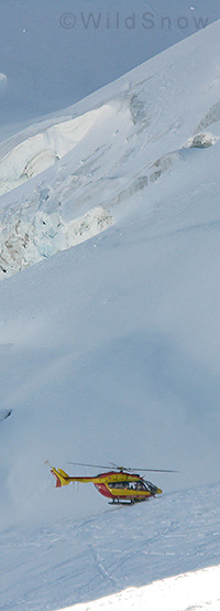 French rescue helicopter picking up a skier on the Grand Montets. French rescue helicopter picking up a skier on the Grand Montets.