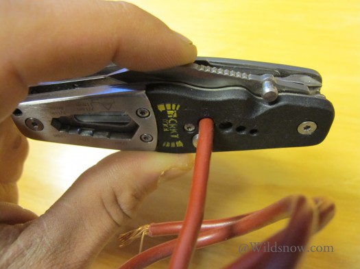 The included wire stripper uses four holes labeled for 16, 14, 12, and 10 AWG wire. To strip a wire, you open the knife blade, insert the wire in the proper hole, and close the knife blade partially so that it presses on the insulation. Pressing down lightly on the blade you rotate the wire to cut around the insulation. The included wire stripper uses four holes labeled for 16, 14, 12, and 10 AWG wire. To strip a wire, you open the knife blade, insert the wire in the proper hole, and close the knife blade partially so that it presses on the insulation. Pressing down lightly on the blade you rotate the wire to cut around the insulation.