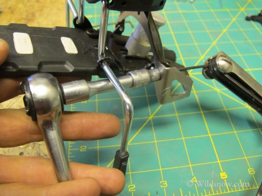 Grasp firmly or clamp ski brake down and bolt each nut with .5mm Allen key. 2 bolts per heelpiece.
