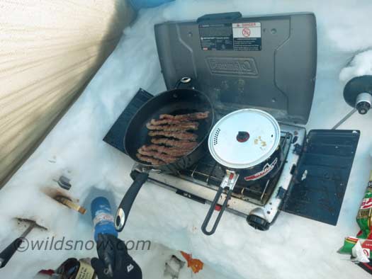 Storm day breakfast involves a lot of bacon. Our cushy camp setup (really just glorified car camping), makes sitting out storm days pretty nice. Storm day breakfast involves a lot of bacon. Our cushy camp setup (really just glorified car camping), makes sitting out storm days pretty nice.
