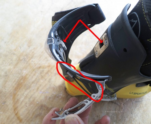 Hook indicated by arrows catches slot in spoiler, is retracted and released by moving the buckle as indicated, which pulls the cable. Quite ingenious and works reliably. Hook indicated by arrows catches slot in spoiler, is retracted and released by moving the buckle as indicated, which pulls the cable. Quite ingenious and works reliably.