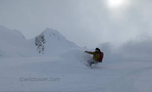 Russel enjoying some powder on the glacier below the peak. Russel enjoying some powder on the glacier below the peak.