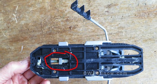 Underside of heel unit, showing flanges that wrap under track, and spring that controls for/aft movement of upper unit as your ski flexes. Underside of heel unit, showing flanges that wrap under track, and spring that controls for/aft movement of upper unit as your ski flexes.