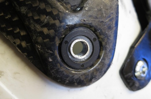 Black nylon washer/bushing in place, centered by virtue of the white nylon bushing protruding slightly above the boot cuff surface. Black nylon washer/bushing in place, centered by virtue of the white nylon bushing protruding slightly above the boot cuff surface.