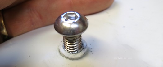 1/4 20 stainless machine screw in the T-nut. The white boss (rim) around the hole is ground off for out bushing mod. 1/4 20 stainless machine screw in the T-nut. The white boss (rim) around the hole is removed for our bushing mod.