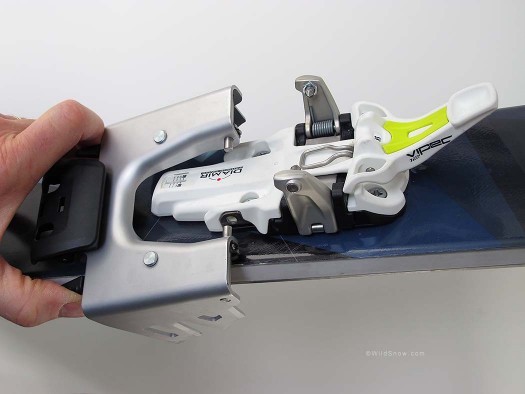 Installing crampon. You squeeze triggers with your fingers then snap the pins into place. Installing crampon. You squeeze triggers with your fingers then snap the pins into place.