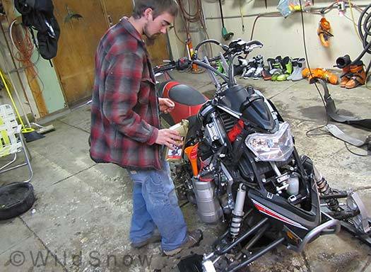 Changing snowmobile oil, Nytro, in the Wildsnow garage workshop. Changing snowmobile oil, Nytro, in the Wildsnow garage workshop.