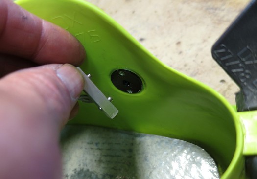 Aluminum shoulder washer is pressed in from the inside, held during tightening with the included spanner as shown.