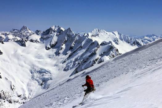 Descending the upper slope on Eldorado in impeccable powder. Forbidden Glacier descent in the background. Mt. Goode in the far horizon.