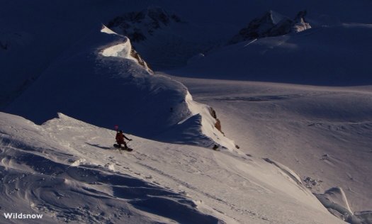 Aaron Diamond on his way down the summit ridge. Ice axe poised and ready as he makes careful, and deliberate turns down. Aaron Diamond on his way down the summit ridge. Ice axe poised and ready as he makes careful, and deliberate turns down.