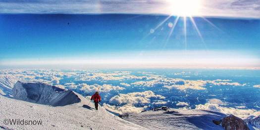 Aaron taking the last few steps to the summit in the never ending evening light. Aaron taking the last few steps to the Denali McKinley summit in the never ending evening light. In this view you're looking south over the Alaska Range.