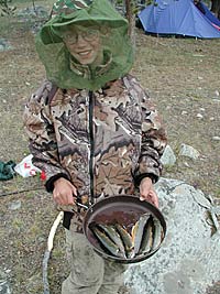 Louie cooking up his first catch. Louie cooking up his first catch.