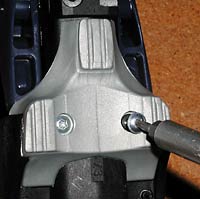 Removing support bumper from bottom of binding. Pry off after you remove the screws. Removing support bumper from bottom of binding. Pry off after you remove the screws.