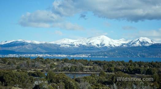 The town of Bariloche can be seen in the distance, nestled between high mountains and an enormous lake. The town of Bariloche can be seen in the distance, nestled between high mountains and an enormous lake.