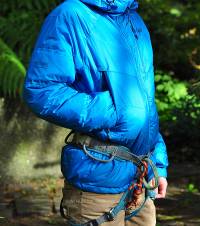 The fleece lined pockets (a HUGE plus) are positioned high enough to be well out of the way of a harness.