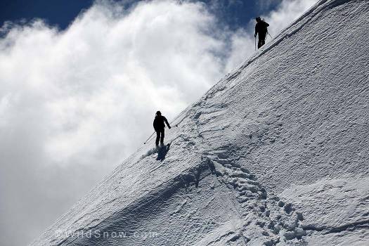 Jim Gile skiing carefully into and over the bergschrund near the summit.
