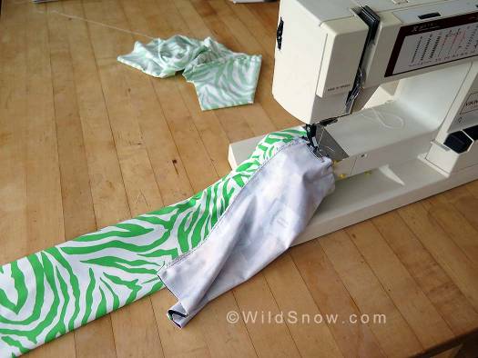 Cut another piece 12x10 inches. Fold over so it's 6x10 inches and sew along the 10 inch length, making a tube that is open on each 6 inch side. Pin both thickness of the 10 inch side to one thickness at the end of the 24 inch tube, leaving the 24 inch tube open at both ends. Cut another piece 12x10 inches. Fold over so it's 6x10 inches and sew along the 10 inch length, making a tube that is open on each 6 inch side. Pin both thickness of the 10 inch side to one thickness at the end of the 24 inch tube, leaving the 24 inch tube open at both ends.