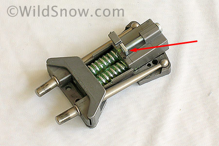 This is what the guts look like flipped over after removal. Arrow points to a small nut on a threaded rod (the vertical DIN adjuster). Before re-assembly make sure this nut is at end of rod as shown. 