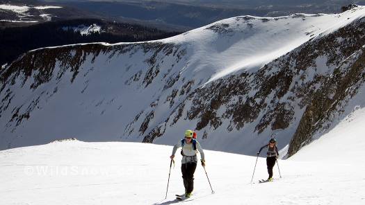 Local skimo champ, Pete Gaston with girlfriend Jordan climbing the saddle below the peak. Local skimo champ, Pete Gaston with Jordan climbing the saddle below the peak.