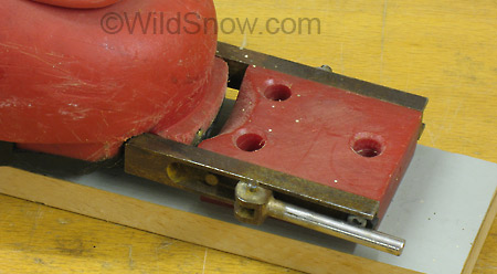Detail of toe unit. The lever operates a cam used to lock and unlock the binding for downhill skiing or touring. Detail of toe unit. The lever operates a cam used to lock and unlock the binding for downhill skiing or touring.
