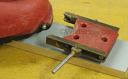 Toe unit detail showing retrofitted ball protruding from boot toe. This was later reversed to the present Dynafit concept of pins that seat in sockets at the toe of the boot. Toe unit detail showing retrofitted ball protruding from boot toe. This was later reversed to the present Dynafit concept of pins that seat in sockets at the toe of the boot.