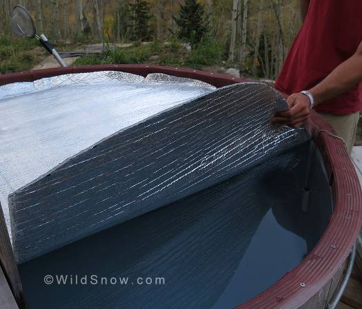 IMG_8341 The original tub cover is made of cedar, and quite heavy to remove. Dust and rain seep between the boards and make the water murky. We made a more user friendly cover out of reflective roll insulation from our local and beloved (kidding) building supply store.