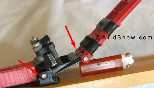IMG_0212-trb-double-pivot-l Double pivot system shown as it might appear mid stride. For the rear pivot to do much the boot had to move up and down against the toe wings. Not ideal. Bic lighter is propping up the plate and giving scale. Click image to enlarge.