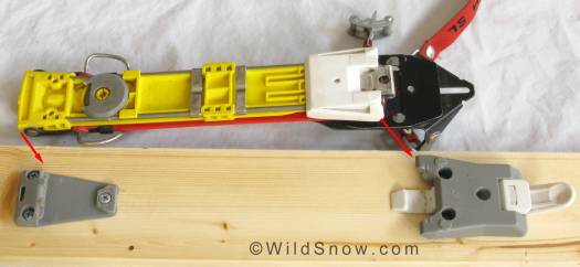 Release plate at top of photo, removed from ski, arrows indicate where plate joins binding fittings that are screwed to the ski. Release plate at top of photo, removed from ski, arrows indicate where plate joins binding fittings that are screwed to the ski.