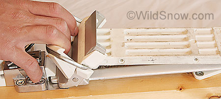 Changing from downhill to touring modes is done by pulling the toe of the binding plate up, which releases the white plastic touring plate from a catch. Reverse procedure changes back to downhill. Both require exiting the binding. Changing from downhill to touring modes is done by pulling the toe of the binding plate up, which releases the white plastic touring plate from a catch. Reverse procedure changes back to downhill. Both require exiting the binding.