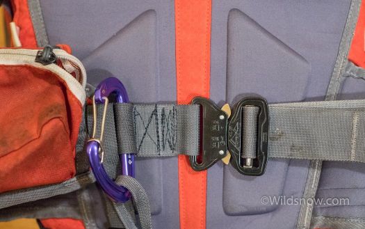 WildsnowEdit (1 of 1) This is the final solution I came up with. I sewed the waist belt webbing with a slot for the carabiner. This holds the carabiner tightly, and makes it not dig into my waist while the belt is cinched down (the stitching to the left of the carabiner is hidden). For the waist buckle, I used a metal