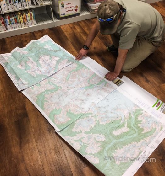 WildsnowEdit (6 of 27) We couldn't find any local maps of the Monarch area, so we bought them in Bella Coola. Here's Eric checking them out on the floor of the local library.