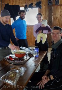Cheese is melting in the wine, babies are being held, and the bread is ready to be cut. Left to right Aaron (the author), Steve, Julie, Aila, Knut. Cheese is melting in the wine, babies are being held, and the bread is ready to be cut. Left to right Aaron (the author), Steve, Julie, Aila, Knut.