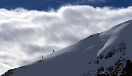 Across valley from Opus, alpine ridges loft above timberline powder terrain.