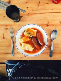 This is why I ski in France. Local pork sausage (name that sausage!), cheesy polenta cakes, and a sauce of course. Plus hot chocolate and a Kronenbourg. Photo by Shannon Sims. This is why I ski in France. Local pork sausage (name that sausage!), cheesy polenta cakes, and a sauce of course. Plus hot chocolate and a Kronenbourg. Photo by Shannon Sims.