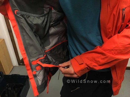 The inner mesh skin/glove/goggle pocket and the lightweight powder skirt. The skirt attaches to the pants with snap closures. The inner mesh skin/glove/goggle pocket and the lightweight powder skirt. The skirt attaches to the pants with snap closures.