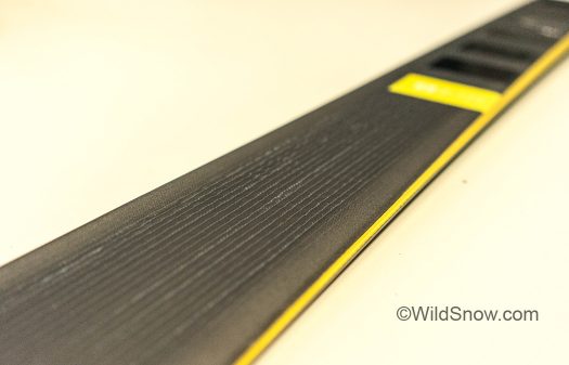 The imperfect grain running down the top of next year’s Helio is the actual carbon in the ski. Real carbon fiber isn’t perfectly strait or symmetrical. Often company’s put a piece of faux carbon on their top-sheet to market the carbon inside, but the imperfections here are like the ski's fingerprint, each being unique.