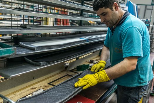 Each layer of the Helio sits on the shelf, a recipe hangs overhead, and the ski mold gets filed with a base, edge, core, carbon, binding plate, and top sheet. Each layer of the Helio sits on the shelf, a recipe hangs overhead, and the ski mold gets filed with a base, edge, core, carbon, binding plate, and top sheet.
