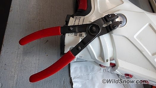 Using circlip pliers to prevent rotation while drilling from inside. A third hand is useful here.