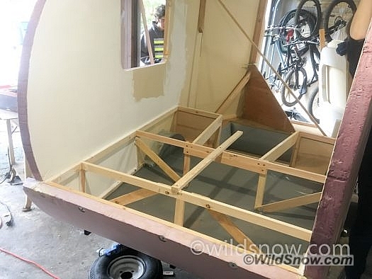 The bed is built with 1x2 wood, to keep it light. The frame is glued and screwed to the foam walls, which adds a significant amount of strength and stiffness to the entire structure.