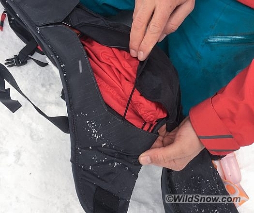 This is the portion of the airbag that inflates first, located on the bottom left side of the pack. It doesn’t have a burst zipper. Instead, it is covered by a simple flap with an elastic cord holding it closed. It opens easily, and I could possibly see it getting filled with snow, perhaps in a fall in deep snow. However, I sacrified in the name of science and took it upon myself to ski deep pow with the pack, and didn’t find any snow getting into the airbag pocket. This is the portion of the airbag that inflates first, located on the bottom left side of the pack. It doesn’t have a burst zipper. Instead, it is covered by a simple flap with an elastic cord holding it closed. It opens easily, and I could possibly see it getting filled with snow, perhaps in a fall in deep snow. However, I sacrificed in the name of science and took it upon myself to ski deep pow with the pack, and didn’t find any snow getting into the airbag pocket.