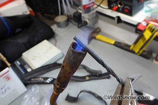 Heated drill bit used to melt hole in the webbing. Heated drill bit used to melt hole in the webbing.
