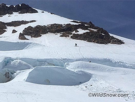 Louie traversing looker's left to navigate around the big crevasses to safely exit to Boulder Glacier.