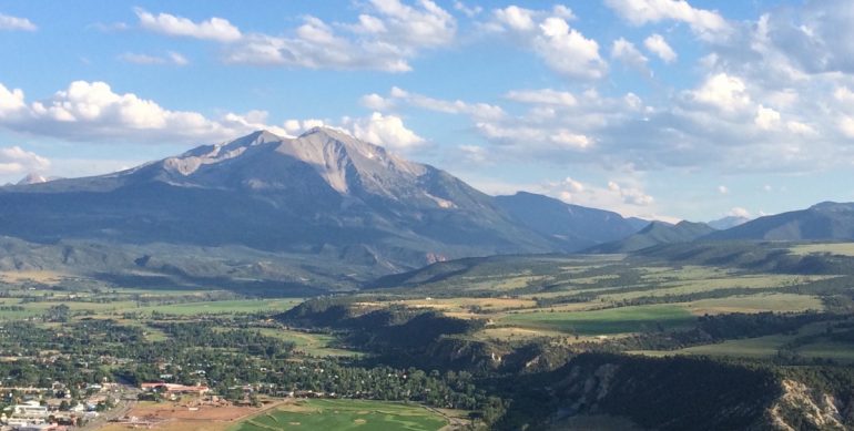 Even void of snow in late summer, Mount Sopris towers over the town of Carbondale, boasting an elevation rise of just under 7000 ft from town to summit.