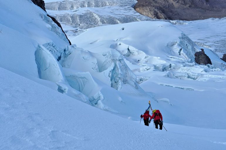Jon Gibons and Steve Marolt ascend the lower slopes of Chumpe.