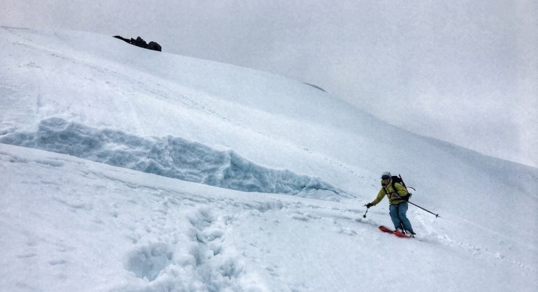 The steeper bit at the top, one of the large cracks visible above the skier.