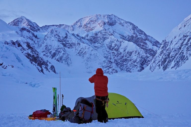 Cal is a religious twice a day flosser. Night one he enjoyed a perfect view of the summit while flossing at our camp on the Lower Kahiltna. Photo @g.allen.smith